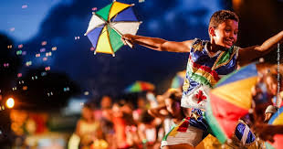 Criança no ombro de um adulto brincando o carnaval